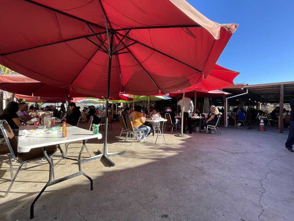Outdoor seating beside a casual seafood restaurant.