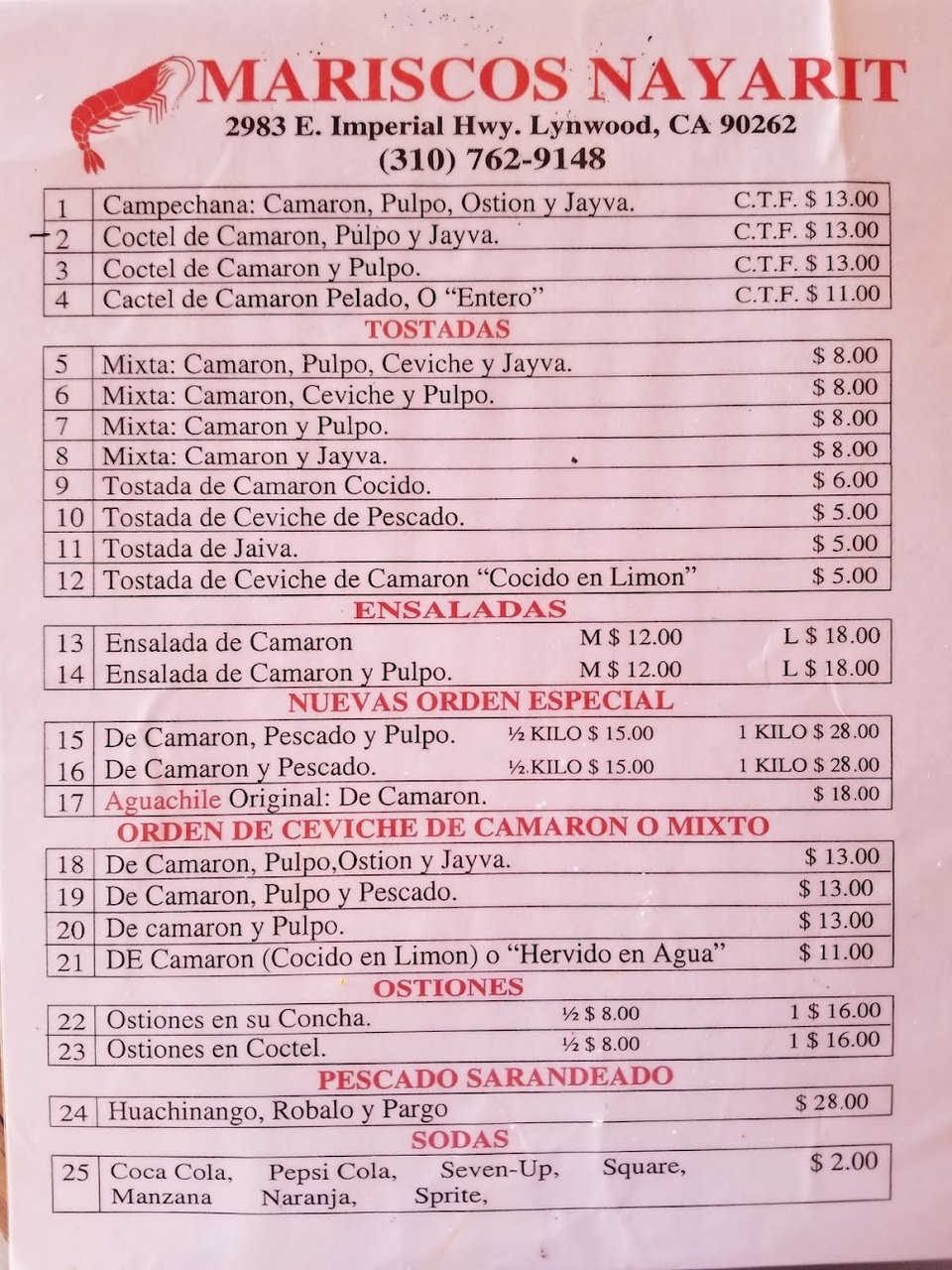 Menu board with Mexican seafood selections and drinks.